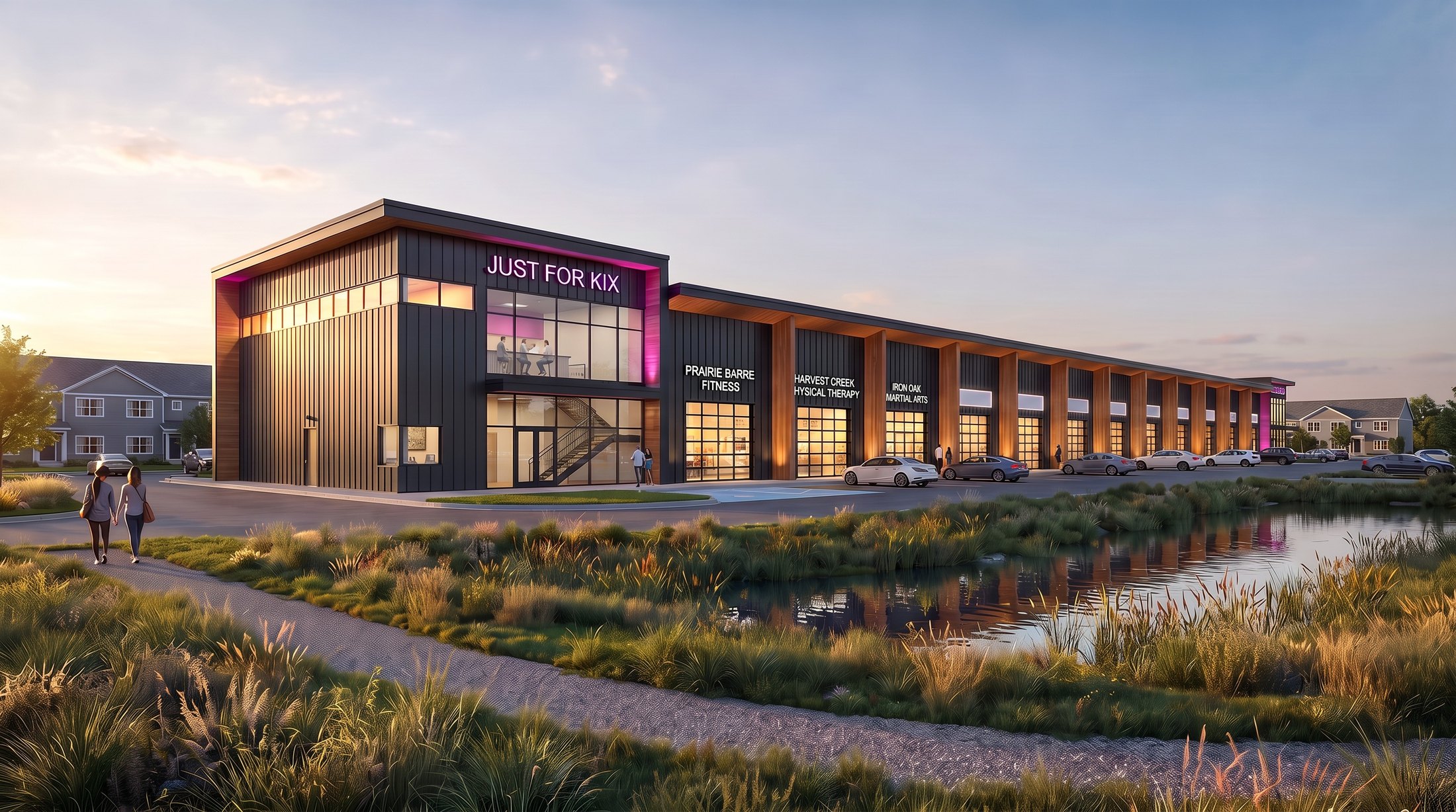 Rendering of a Next To Kix building at dusk: a Just For Kix dance studio with a lit sign over a two-story glass front, then a row of black-and-cedar storefront suites with glass overhead doors